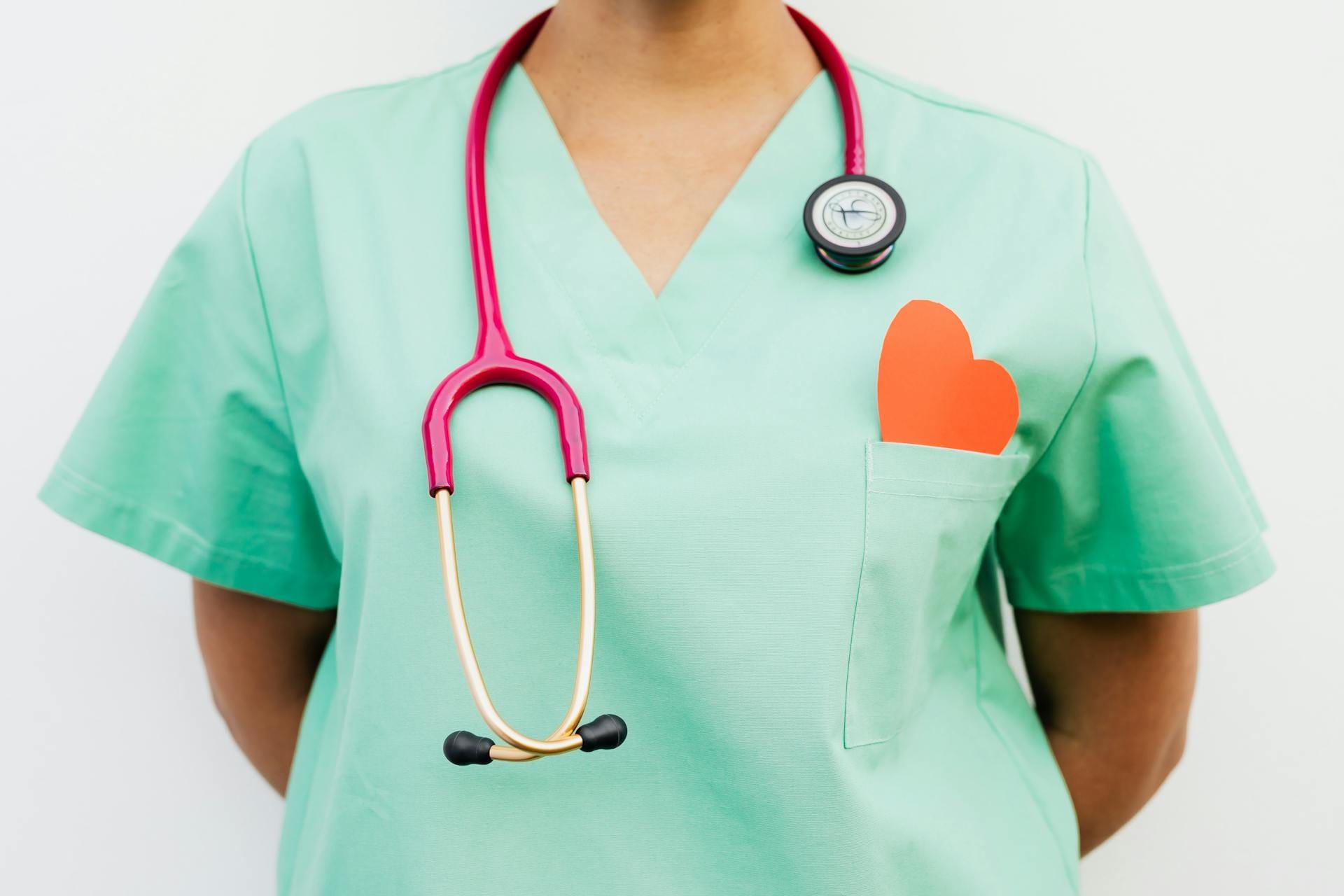 A Stethoscope Hanging on Medisense Medical Professional's Neck Wearing a Green Uniform, in Australia