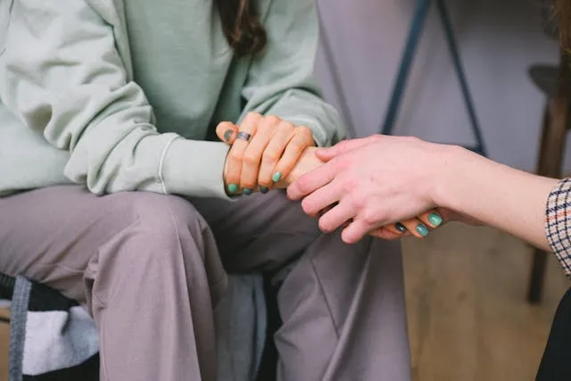 Crop Medisense psychologist supporting patient during counseling indoors at home in Australia