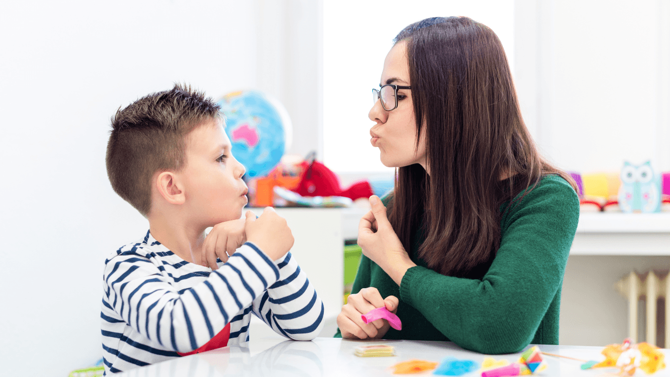 Children speech therapy concept. Preschooler practicing correct pronunciation with a female speech therapist.