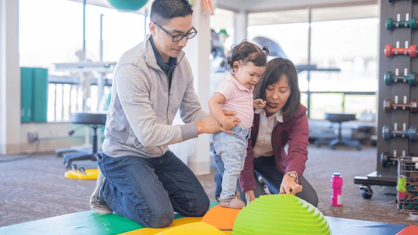 Occupational therapist doing play therapy with a toddler-age girl
