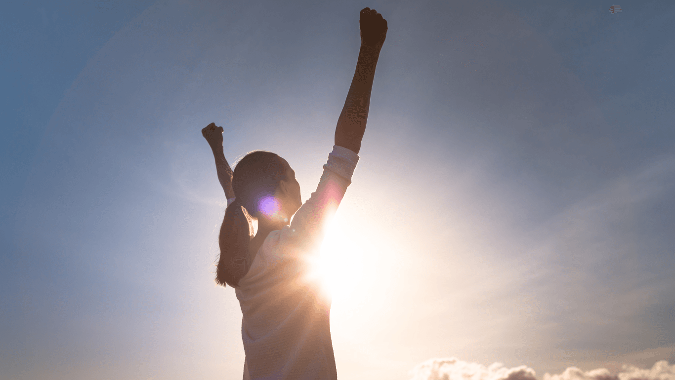 Strong woman overcoming adversity. Woman with fist up to the sky