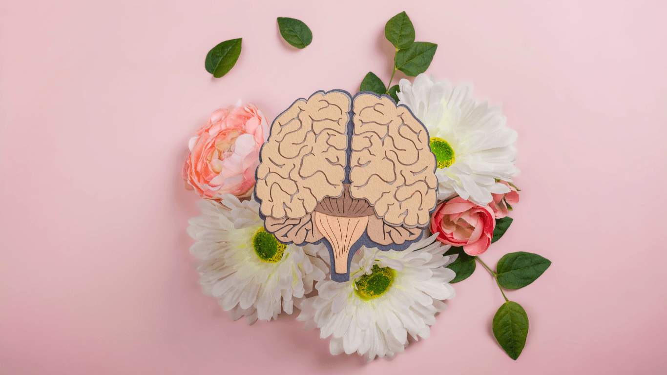 brain with flowers and green leaves on pink background