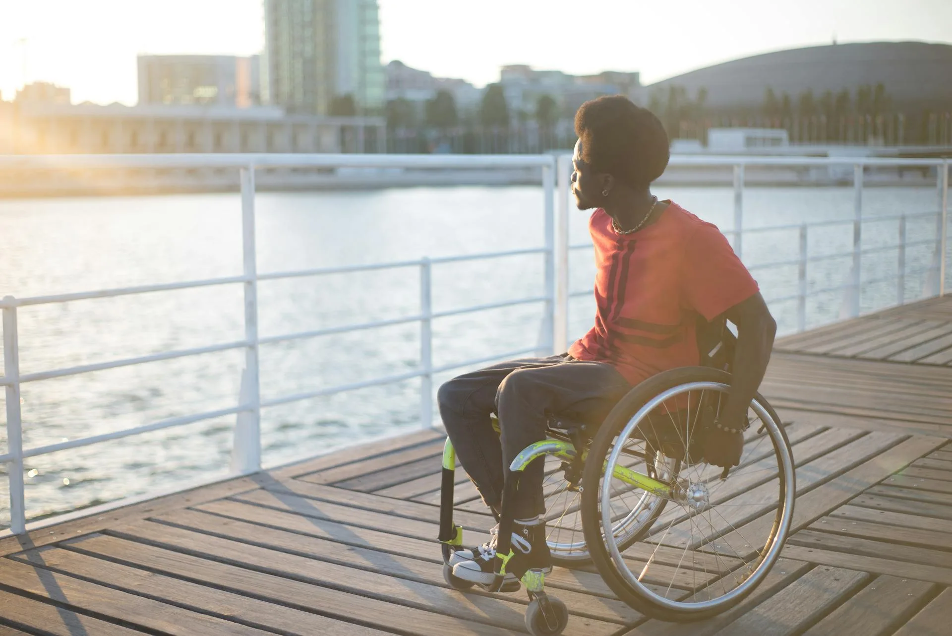 Man on Wheelchair Looking Away with happiness after receiving aid from Medisense's Allied health services in Australia