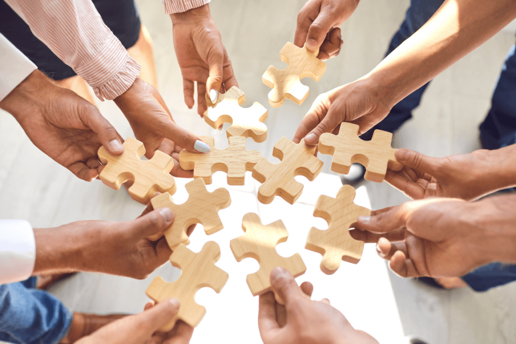 Medisense therapists holding puzzle pices to join together in provinding the best Allied health services in Australia