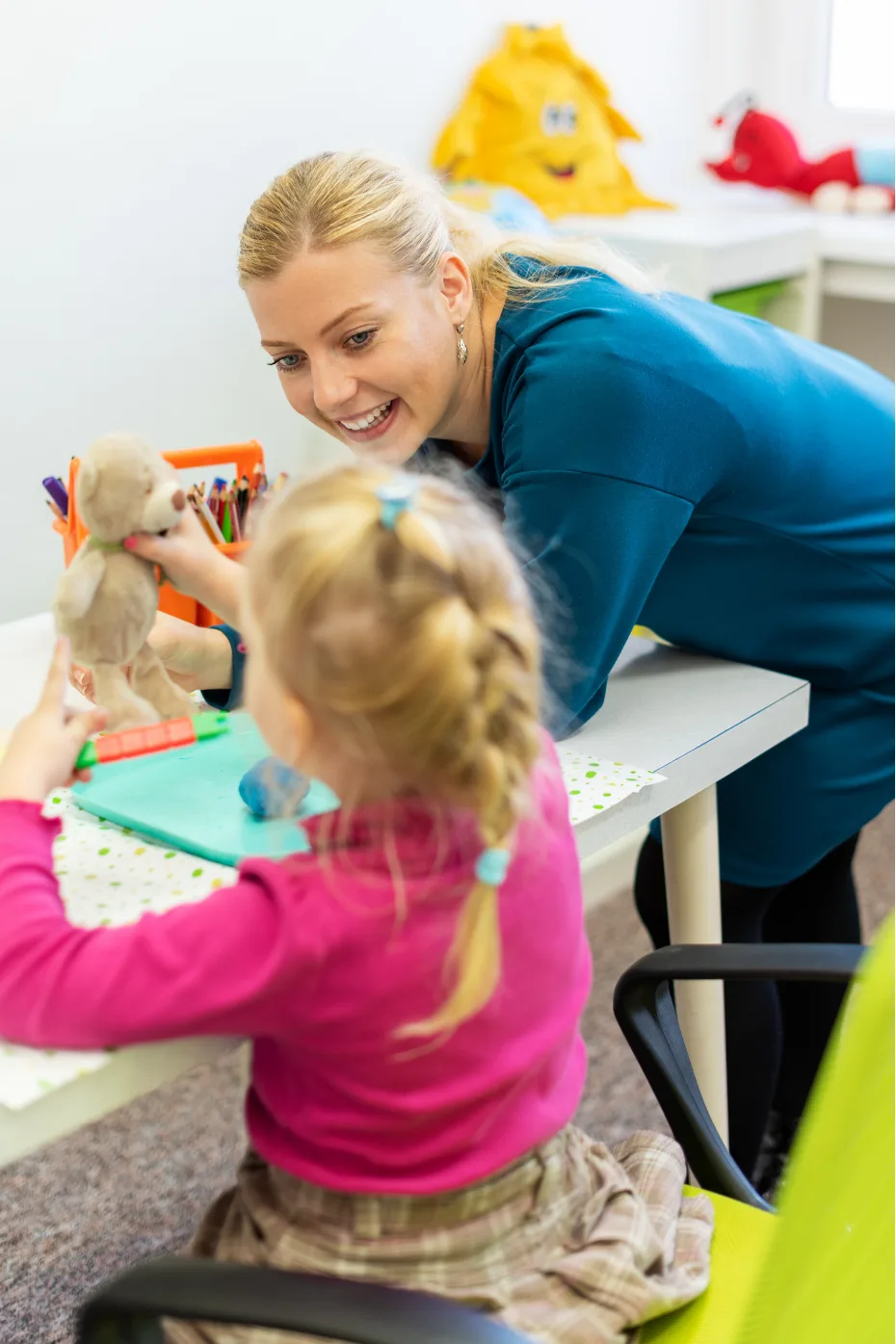 Toddler girl in child occupational therapy session in Austrlia, doing sensory playful exercises with her Medisense therapist - Allied health services Australia